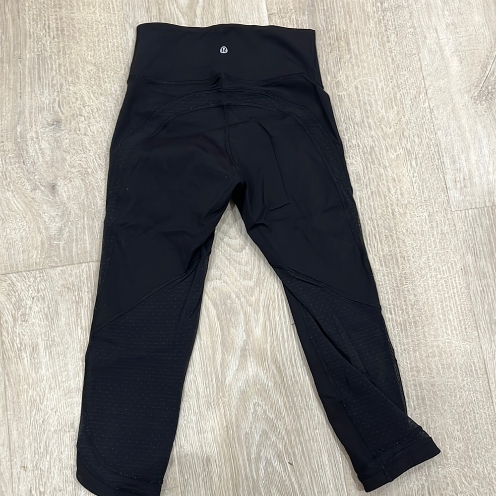 Lululemon cropped leggings. Sheer dotted details on back and bottoms. Size 4